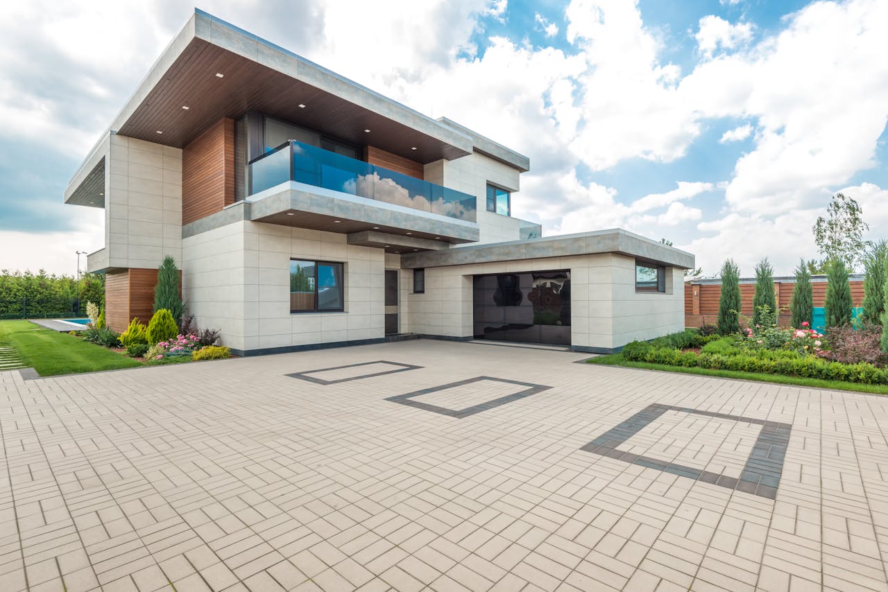 The Art of Drawing Readers In: Your attractive post title goes here Elegant modern house exterior with lush greenery and ample driveway space.